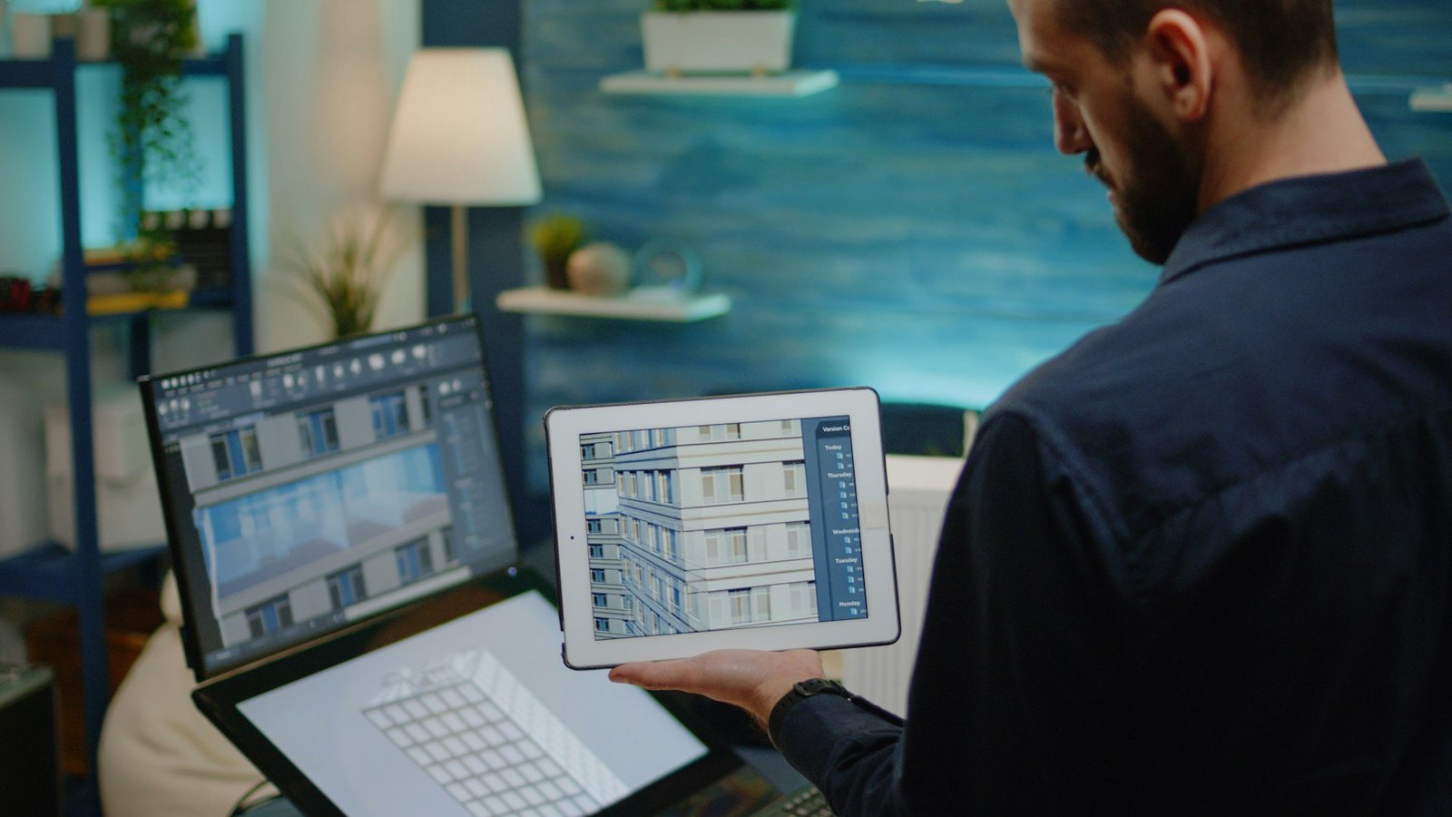 architect holding digital tablet with building model.jpg